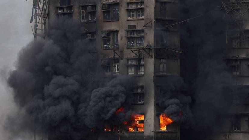 Thick smoke billows from the upper floors of a residential block at Wang Fuk Court housing estate during a major fire that engulfed bamboo scaffolding across multiple buildings, in Tai Po, Hong Kong