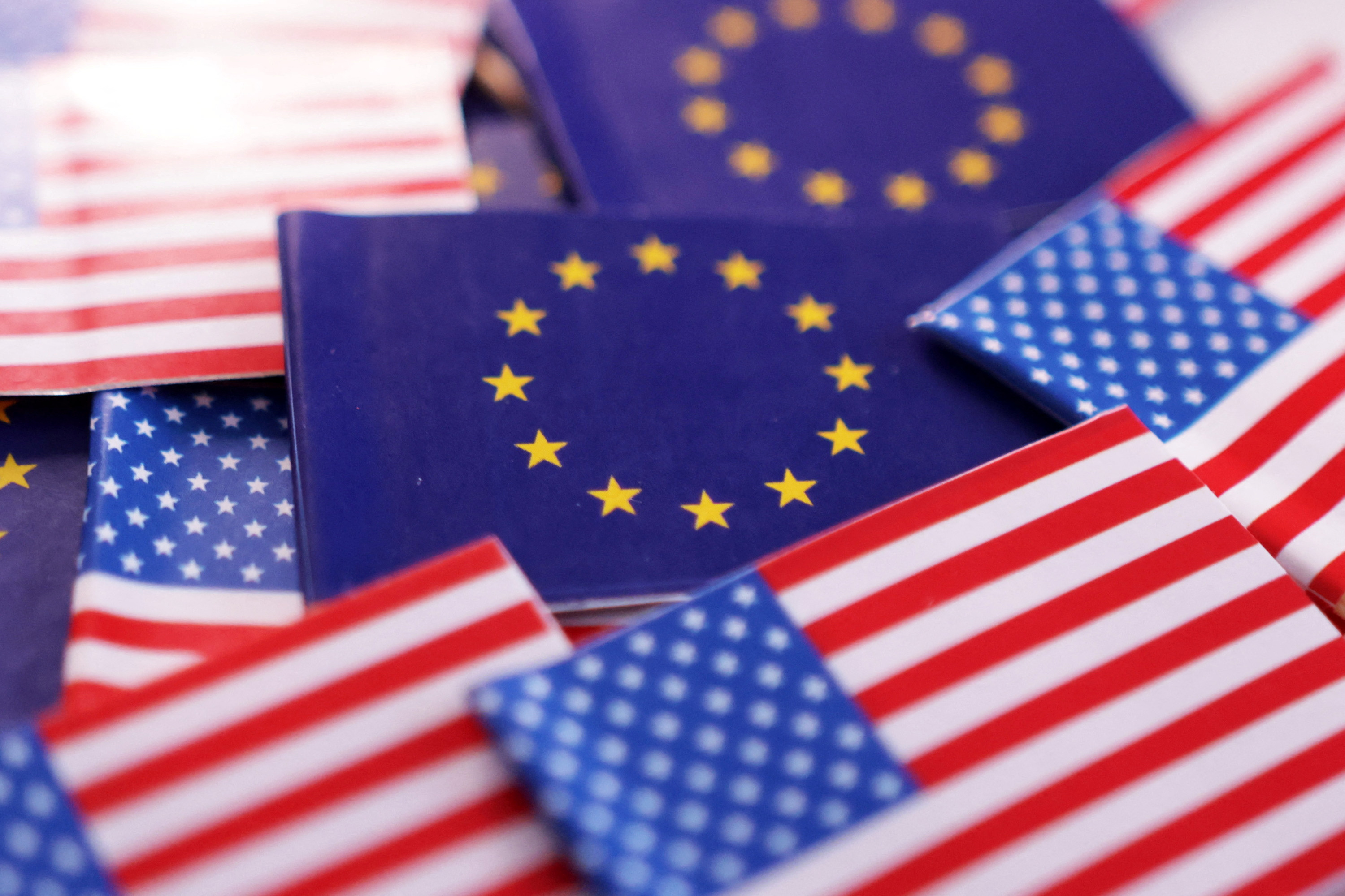 Illustration shows U.S. and EU flags