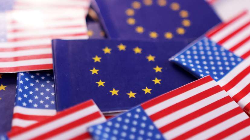 Illustration shows U.S. and EU flags