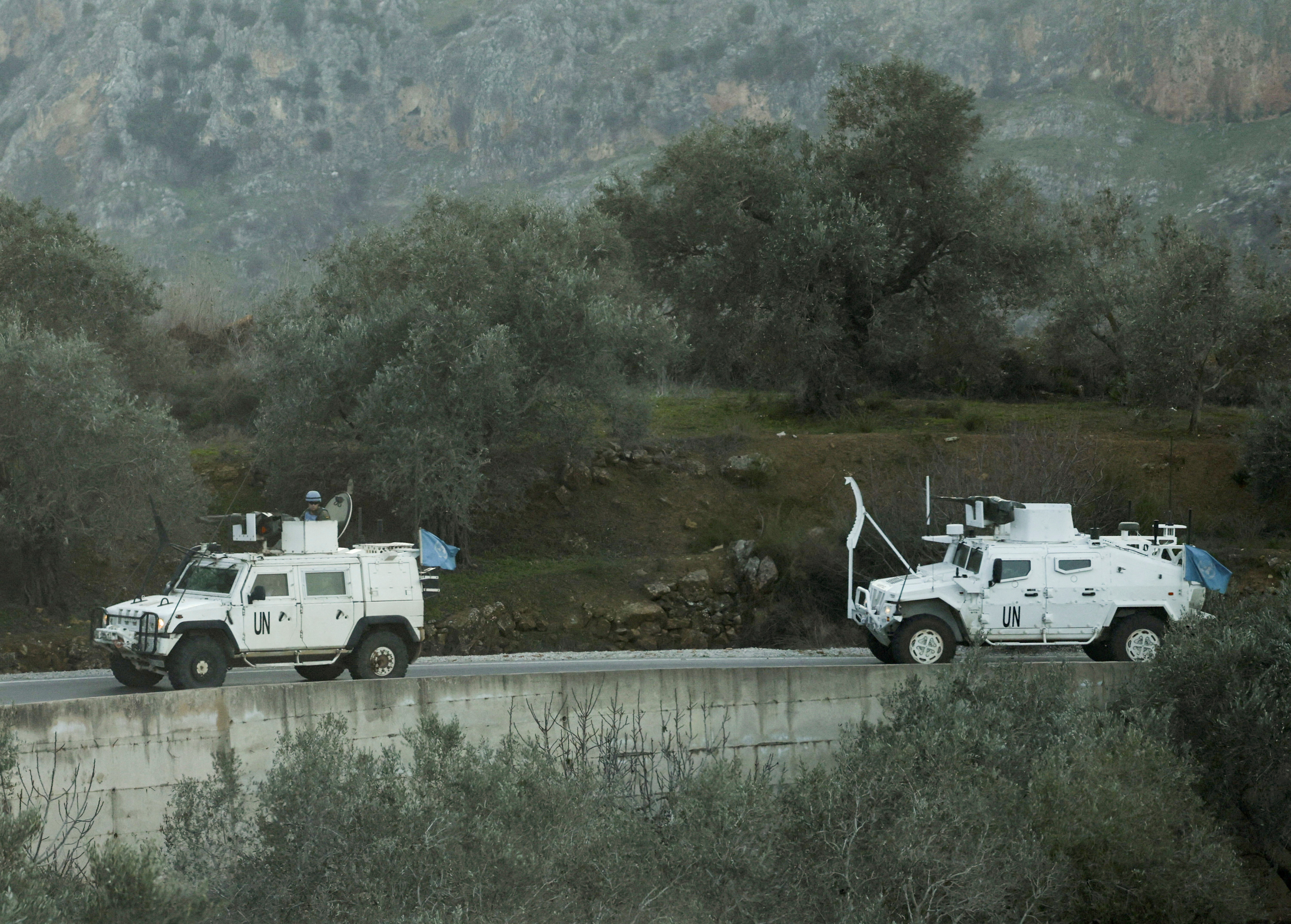 FILE PHOTO: UN peacekeepers (UNIFIL) vehicles ride along a street in Marjaayoun