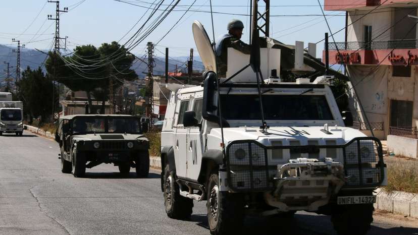 United Nations peacekeepers (UNIFIL) and Lebanese army vehicles drive in the town of Qlayaa