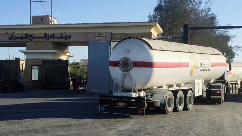 Trucks carrying humanitarian aid line up at the Rafah border on the Egypt side