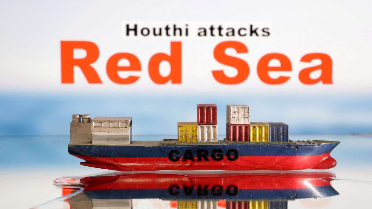 FILE PHOTO: Illustration shows a cargo ship boat model and "Red Sea" and "Houthi attacks" words