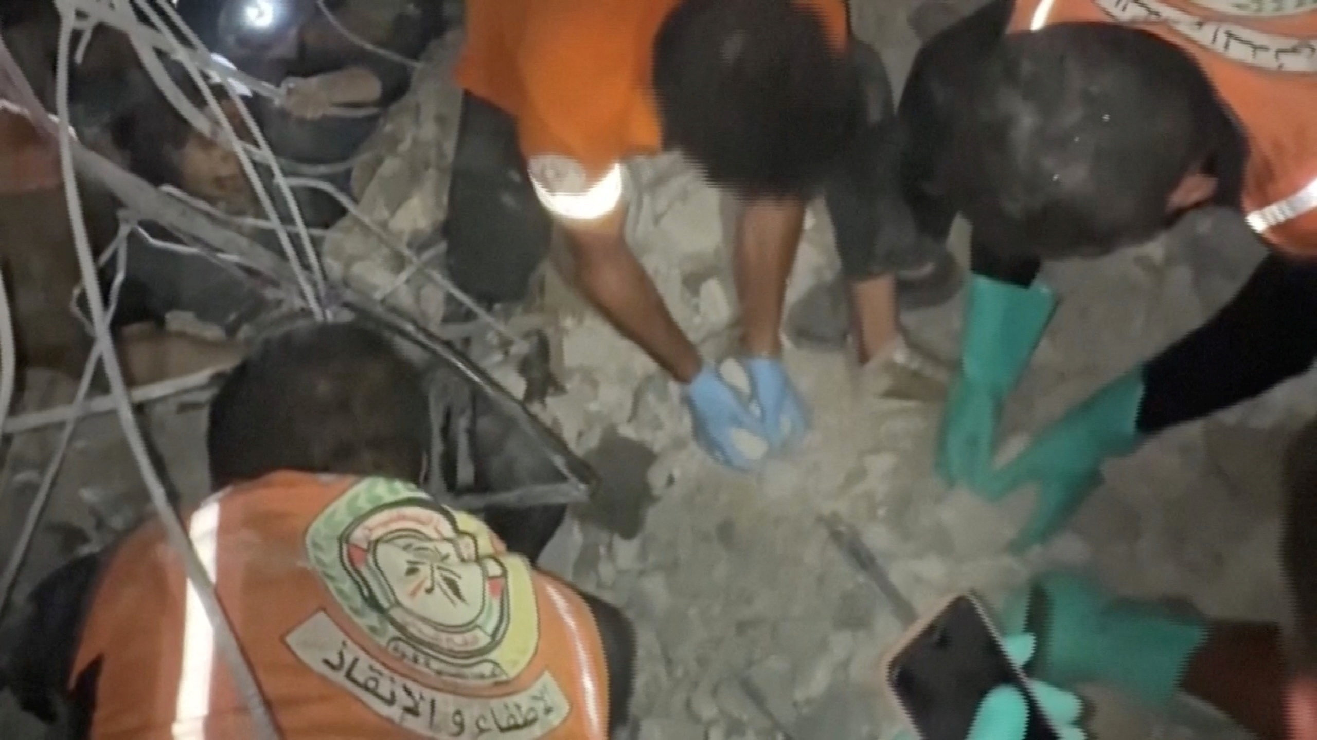 Rescuers work to free people trapped in rubble after an Israeli strike in Gaza City