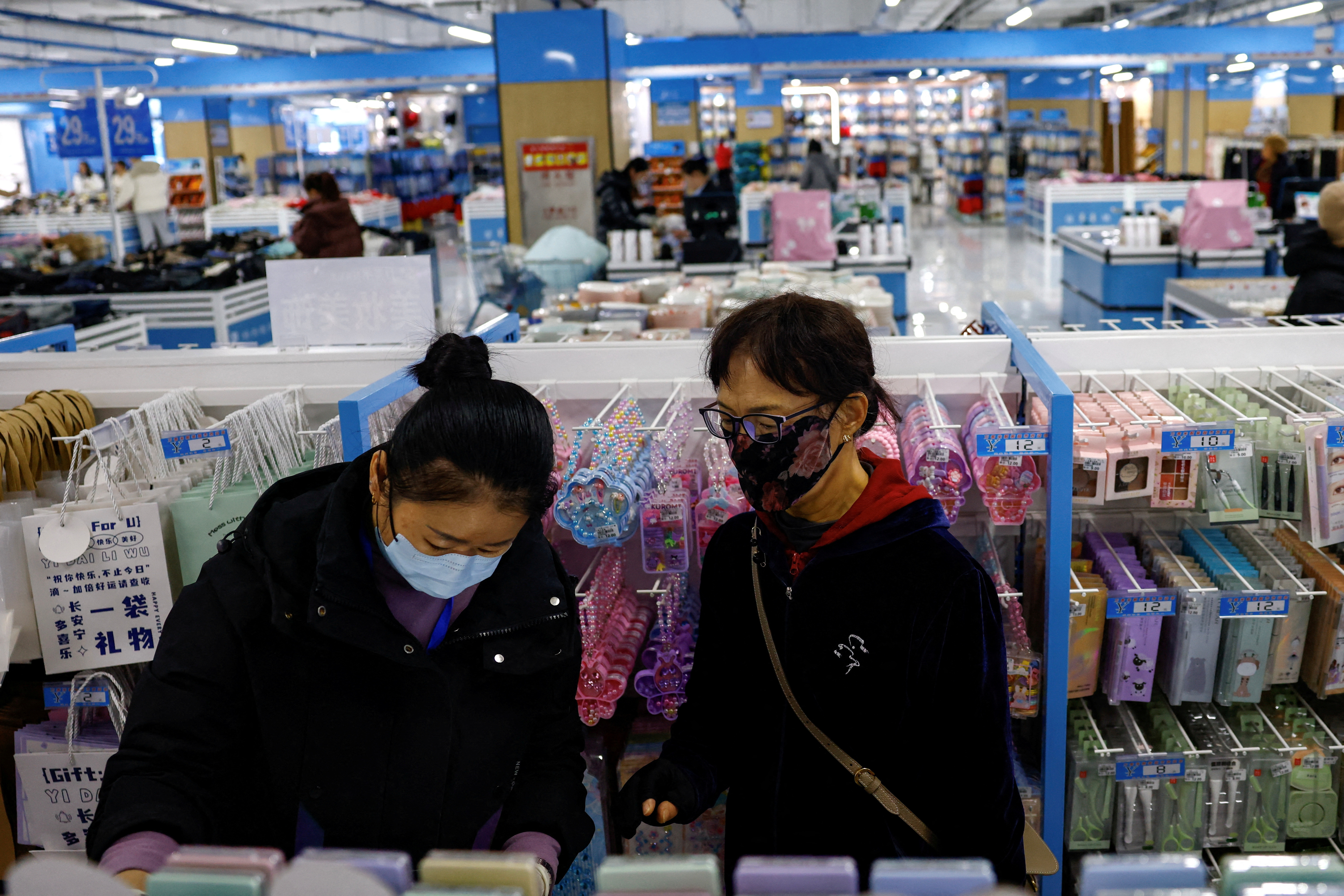 FILE PHOTO: Customers shop at the Wankelai store in Beijing