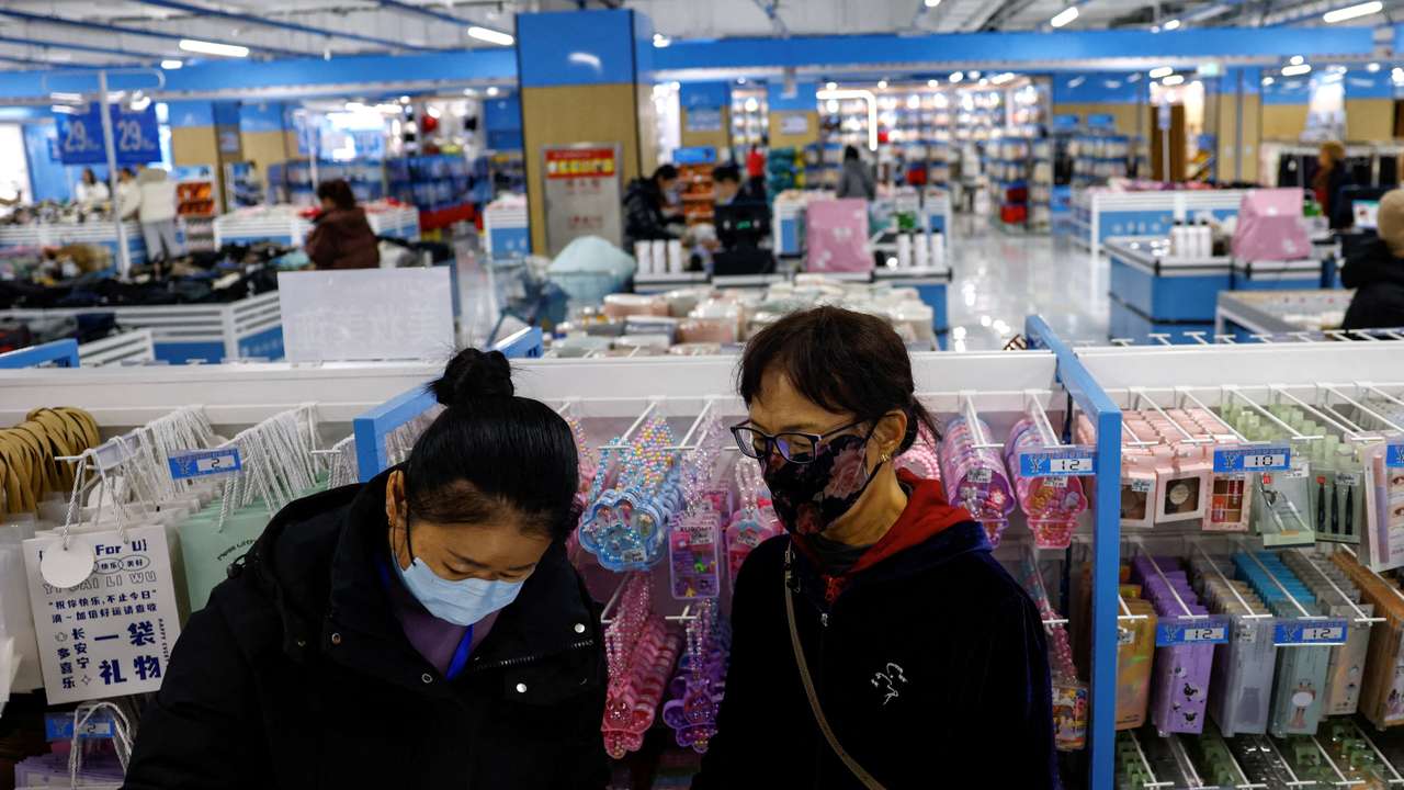 FILE PHOTO: Customers shop at the Wankelai store in Beijing