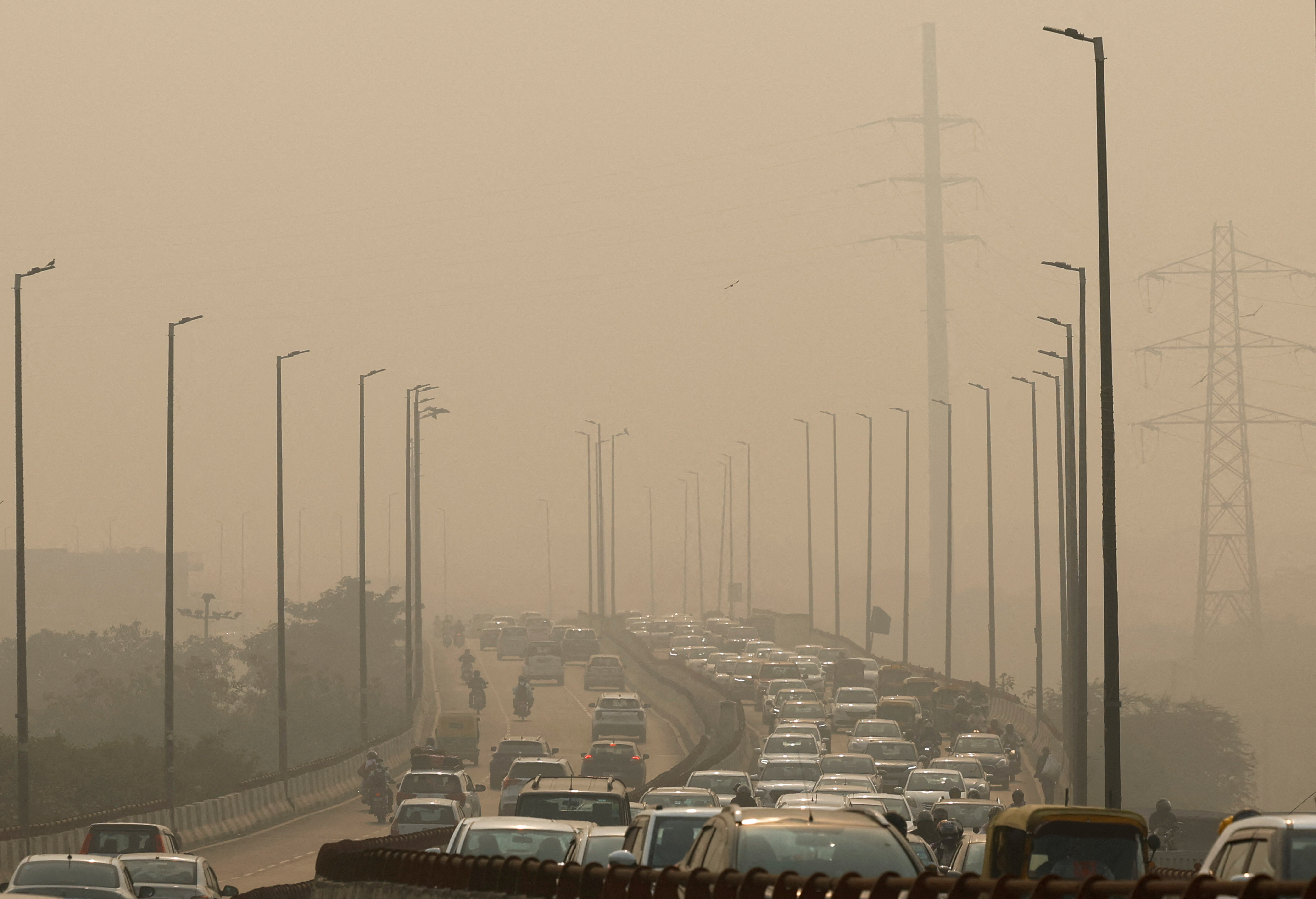 FILE PHOTO: Vehicles drive on a highway on a polluted smoggy morning in New Delhi