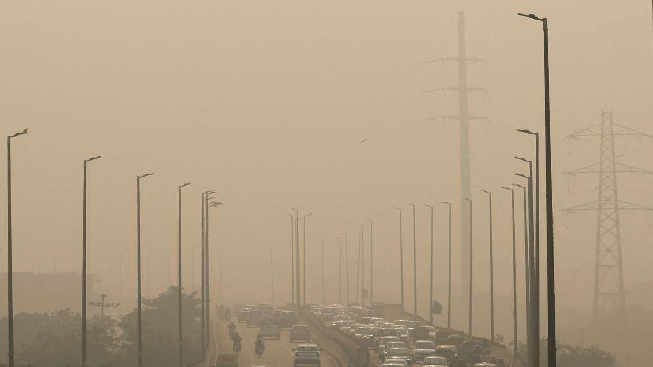 FILE PHOTO: Vehicles drive on a highway on a polluted smoggy morning in New Delhi