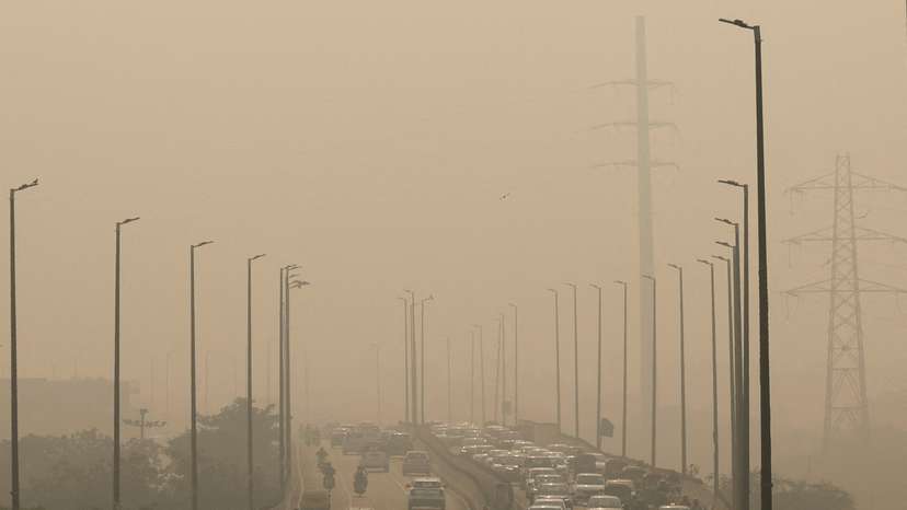 FILE PHOTO: Vehicles drive on a highway on a polluted smoggy morning in New Delhi