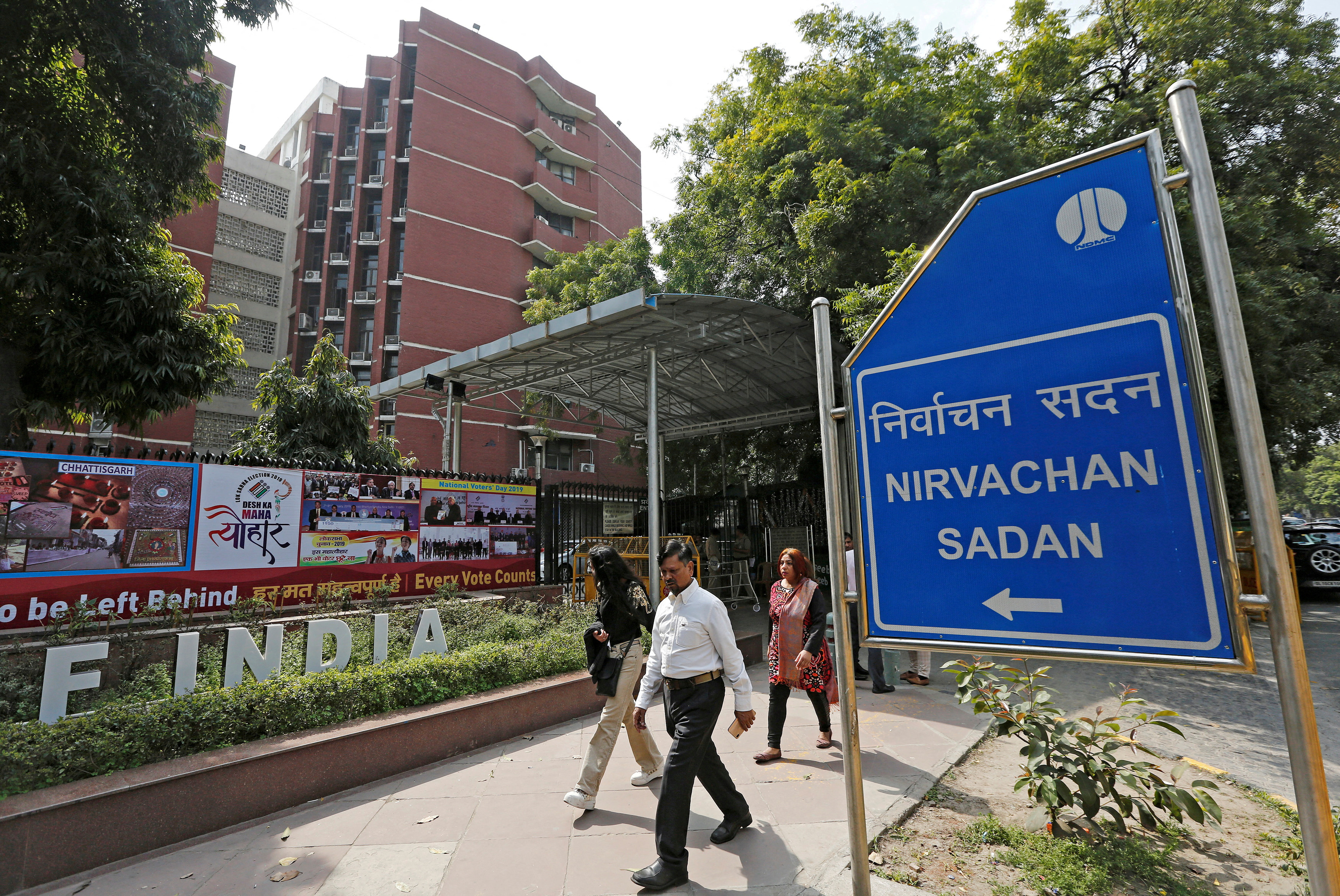 FILE PHOTO: People walk past the Election Commission of India office building in New Delhi