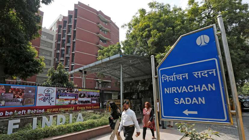 FILE PHOTO: People walk past the Election Commission of India office building in New Delhi