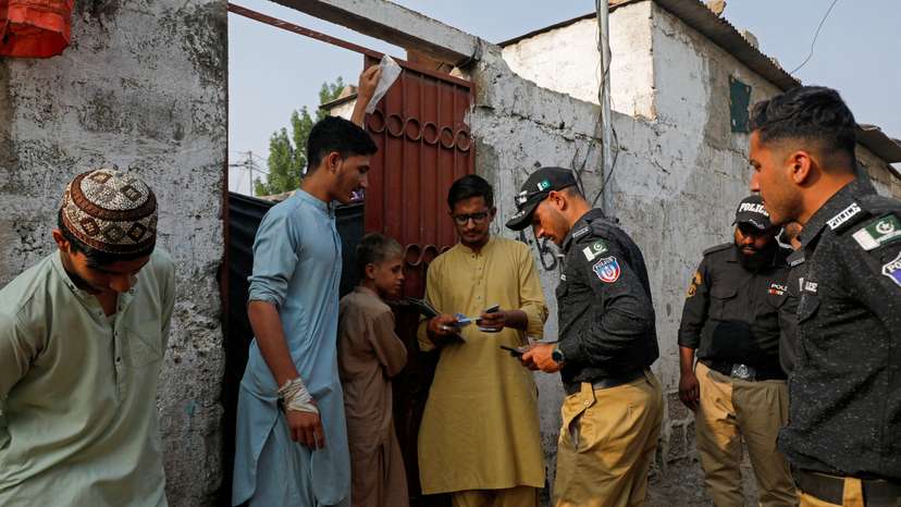 FILE PHOTO: Police conduct a search and verification drive for undocumented Afghan nationals, on the outskirts of Karachi