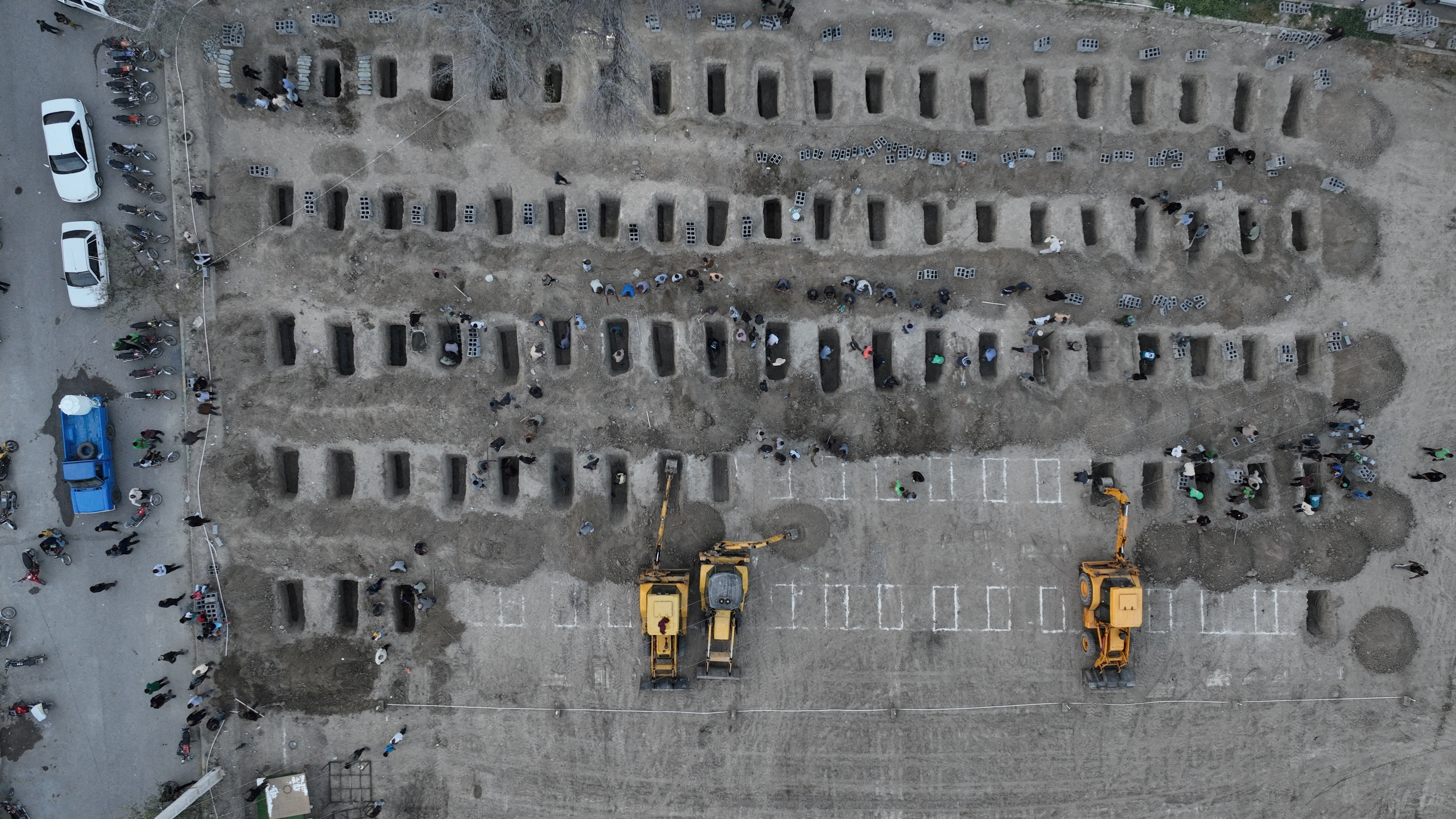 FILE PHOTO: Graves are being prepared for the victims following a reported strike on a school in Minab