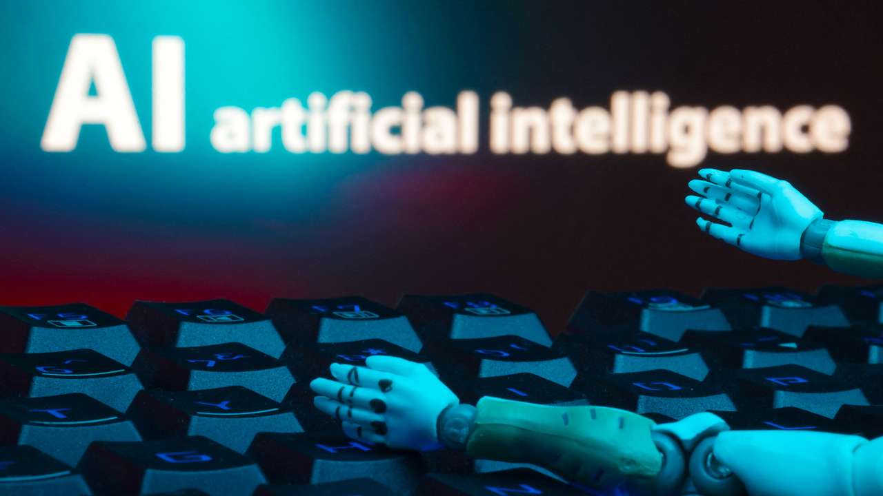 Illustration shows message reading "AI artificial intelligence", keyboard and robot hands