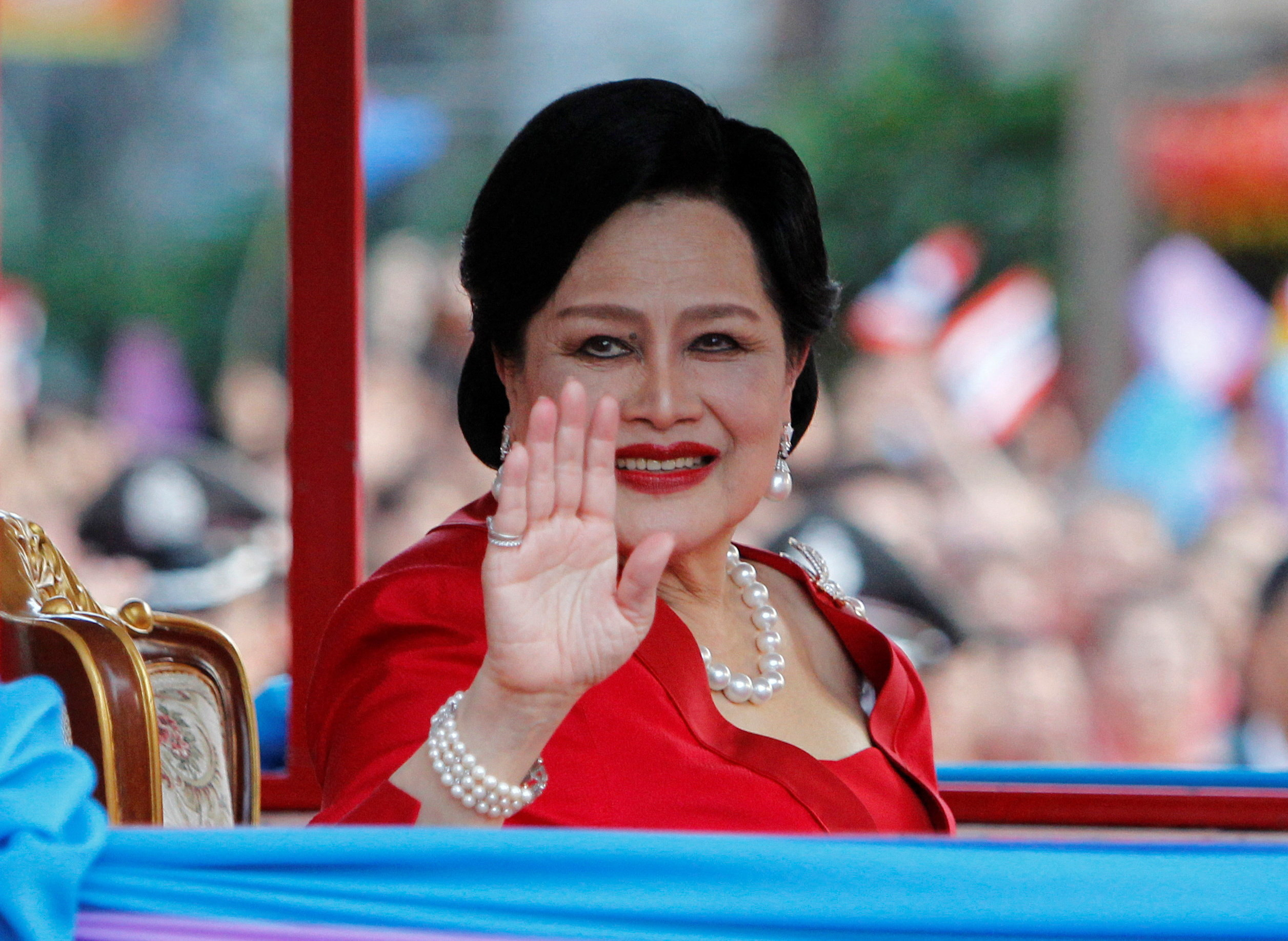 FILE PHOTO: Thailand's Queen Sirikit waves to people during her arrival in Chinatown for Lunar New Year celebrations in Bangkok