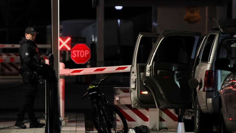 Members of the U.S. Secret Service check the site of a vehicle crash on a perimeter gate of the White House, in Washington
