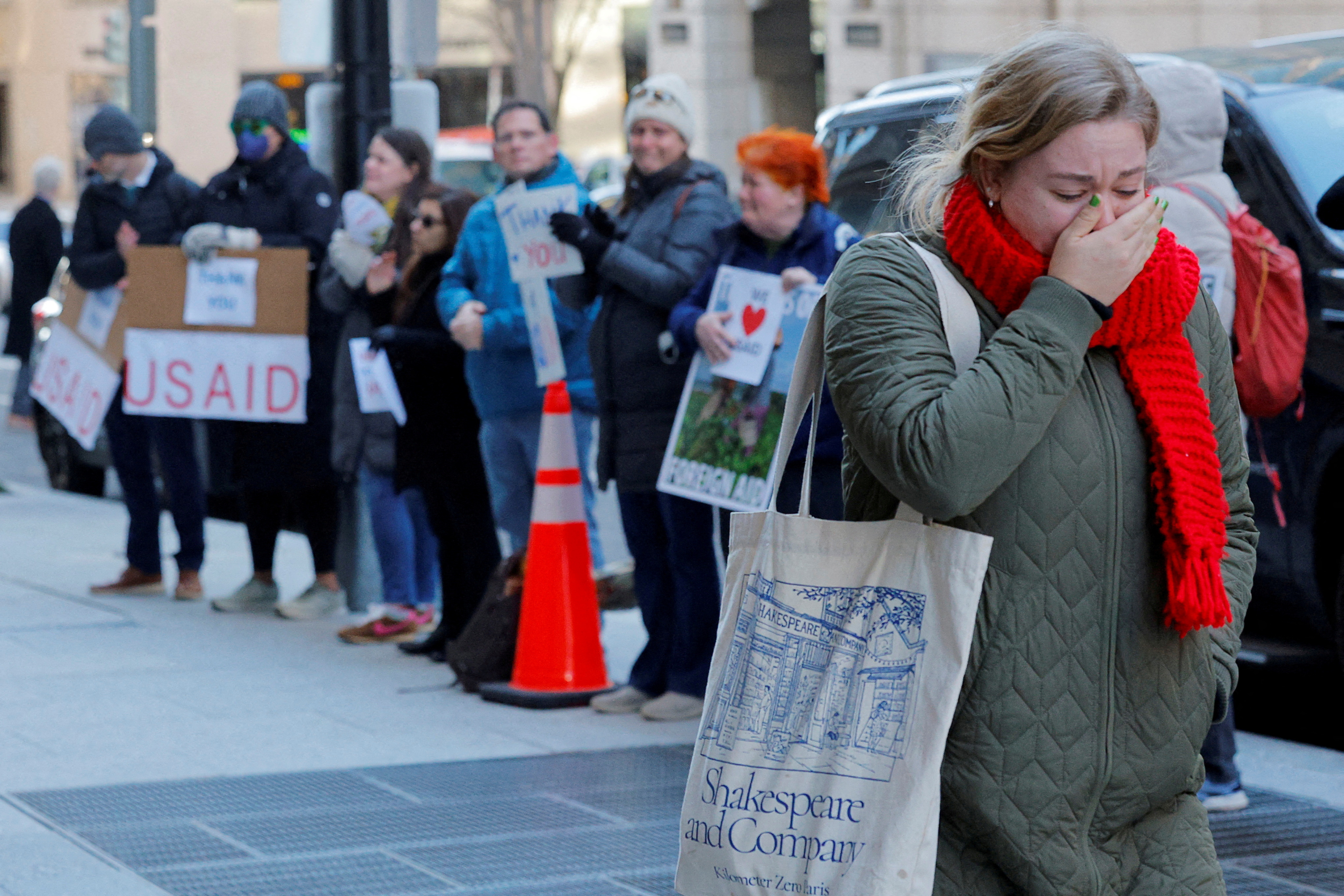 FILE PHOTO: Recently fired USAID staff  leave the office in Washington