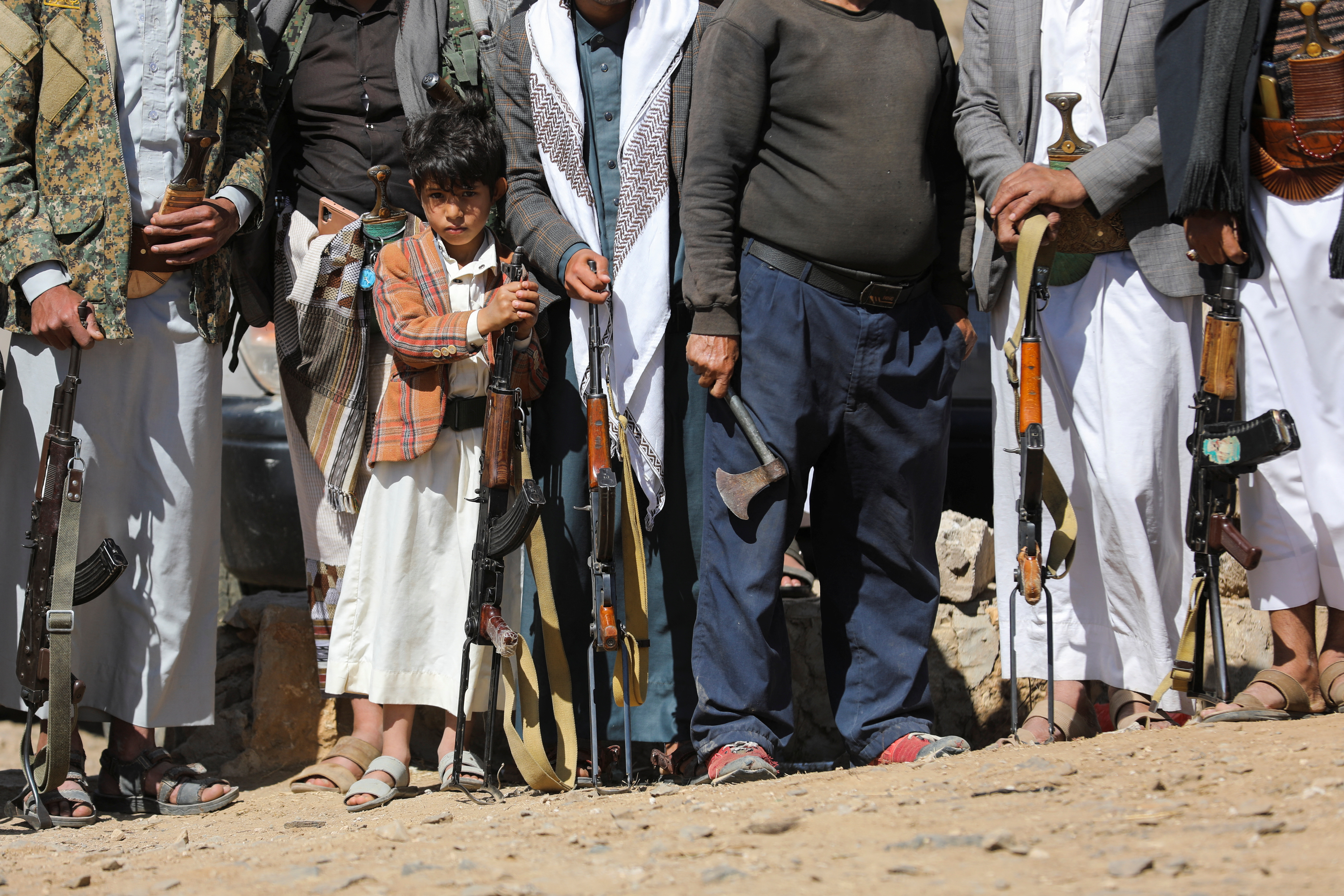 Boy holds a rifle as he takes part in a pro-Palestinian protest by Houthi supporters in Sanaa