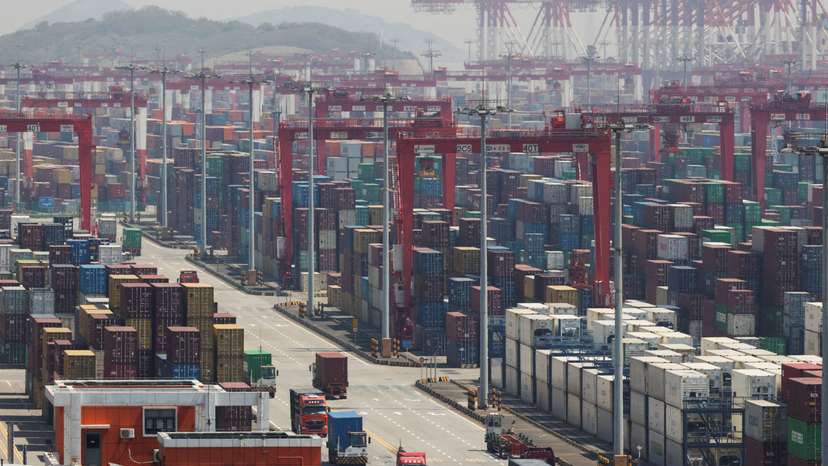 Gantry cranes stand near shipping containers at Yangshan Port outside of Shanghai
