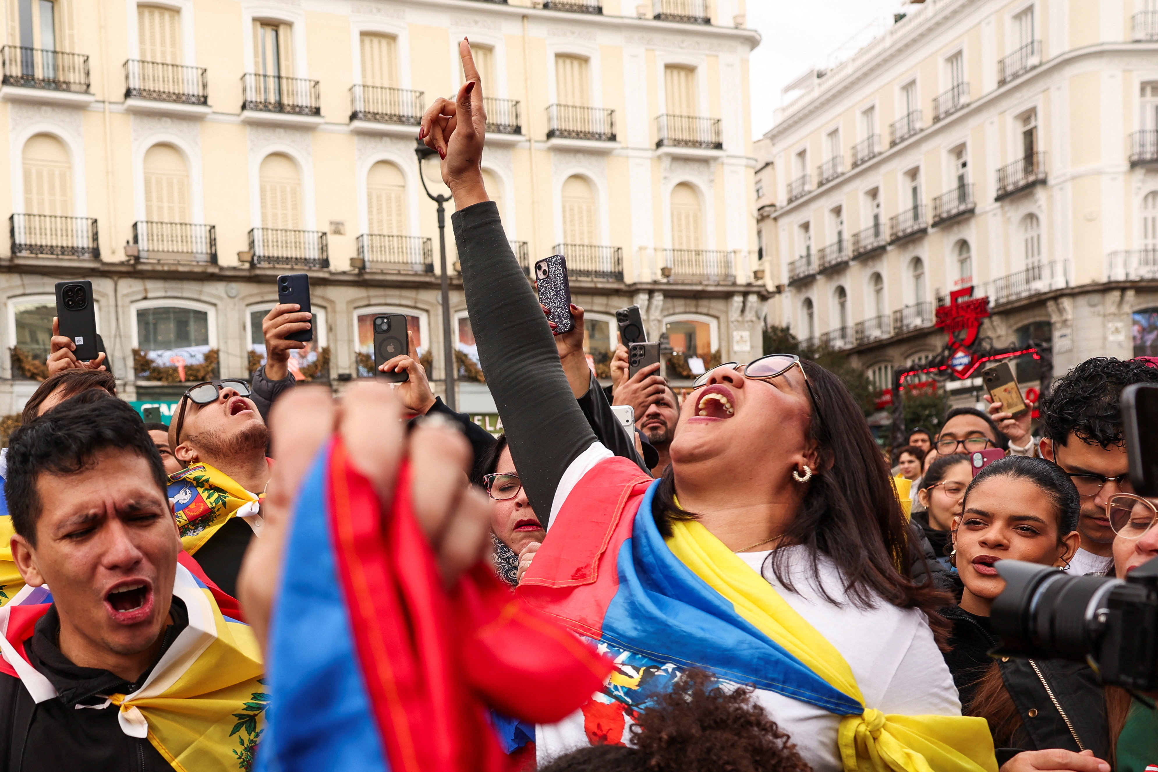 People react to the news of U.S. strikes on Venezuela and capture of President Maduro, in Madrid