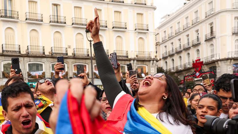 People react to the news of U.S. strikes on Venezuela and capture of President Maduro, in Madrid