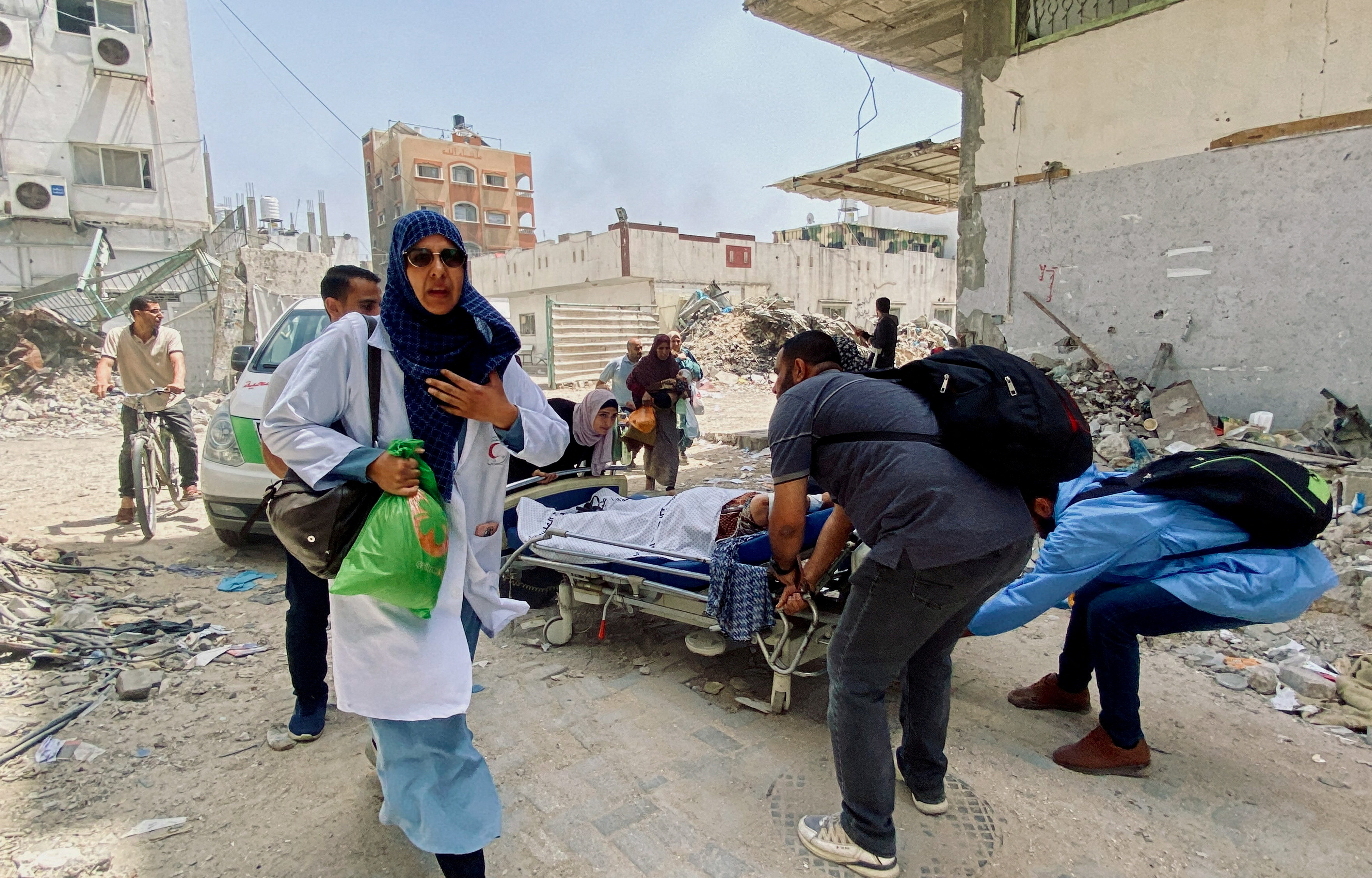 FILE PHOTO: Palestinians evacuate Kamal Adwan hospital following an Israeli strike, in Beit Lahia
