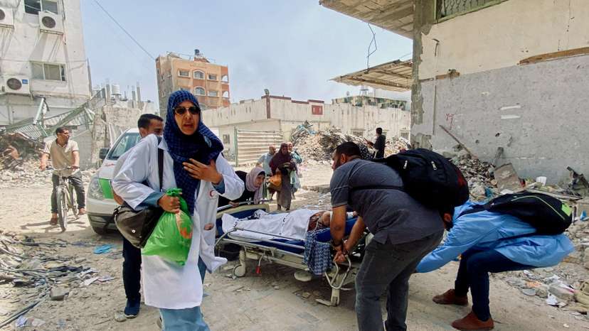 FILE PHOTO: Palestinians evacuate Kamal Adwan hospital following an Israeli strike, in Beit Lahia