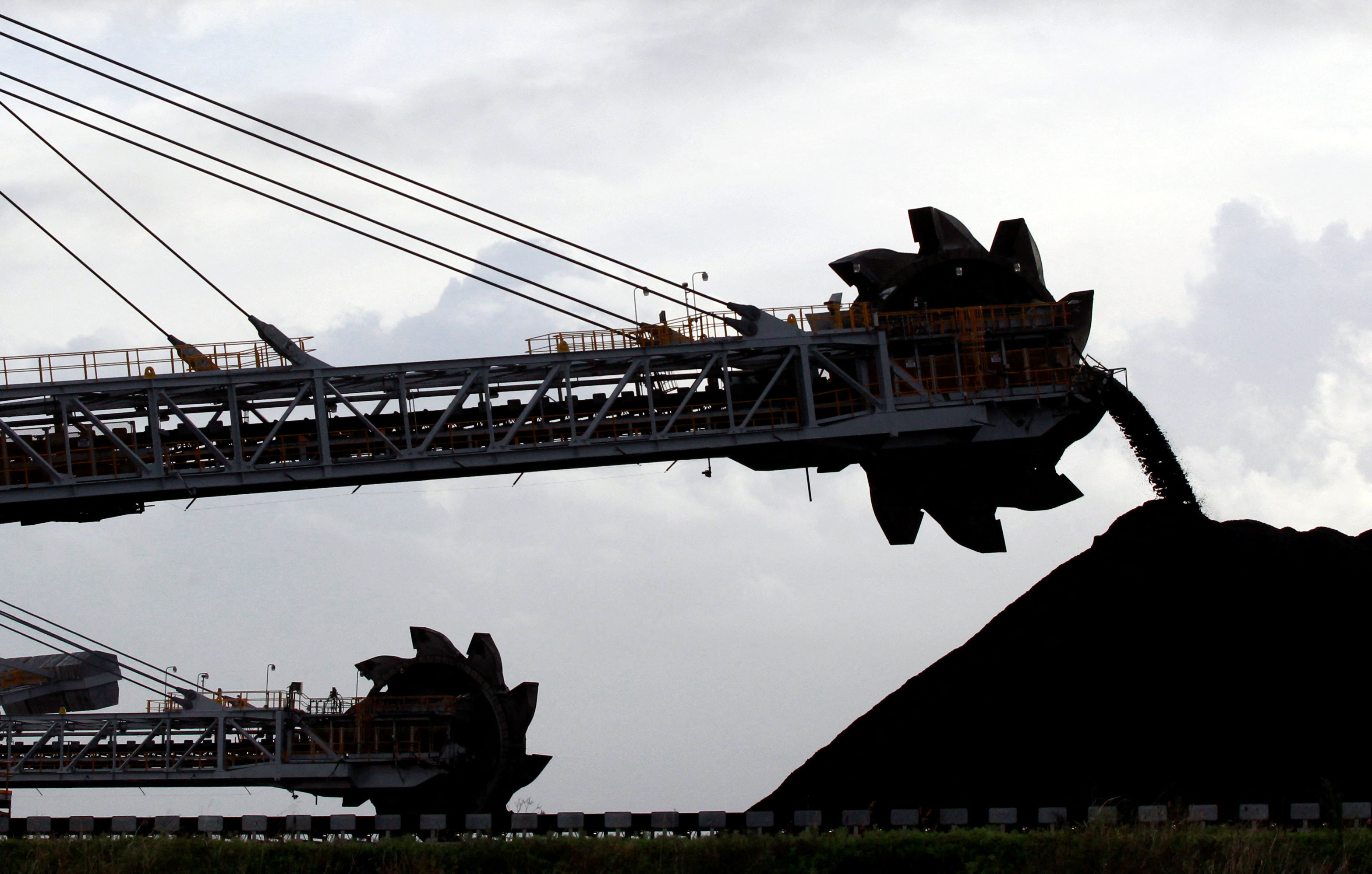 FILE PHOTO: A stacker/reclaimer places coal in stockpiles at the port in Newcastle, Australia