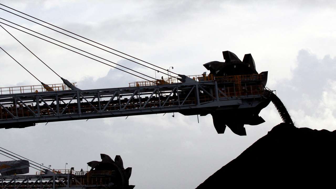 FILE PHOTO: A stacker/reclaimer places coal in stockpiles at the port in Newcastle, Australia