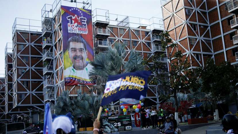 FILE PHOTO: Signs showing Venezuela's President Nicolas Maduro and pro-Maduro slogans, in Caracas