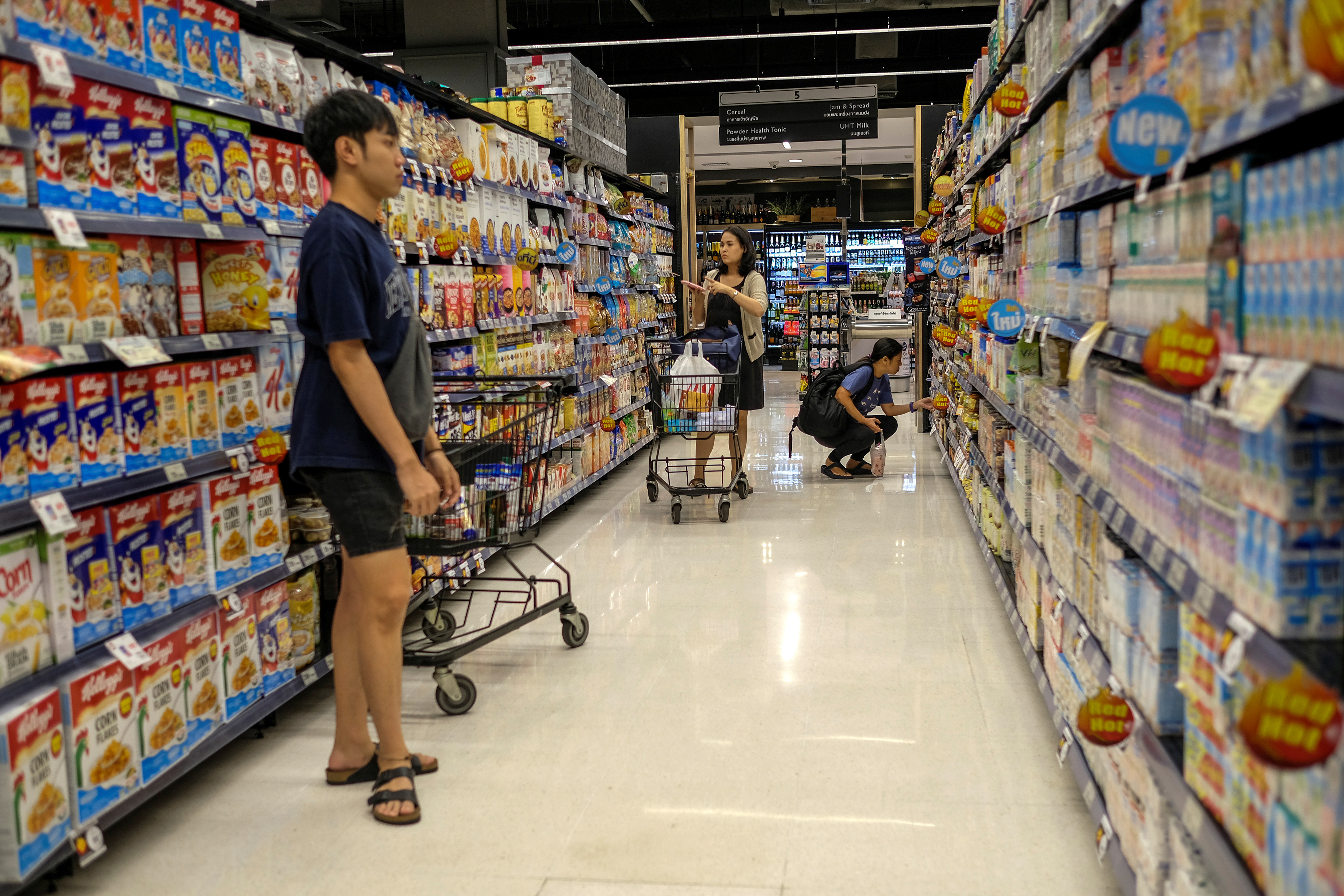 People shop at a supermarket inside a department store in central Bangkok