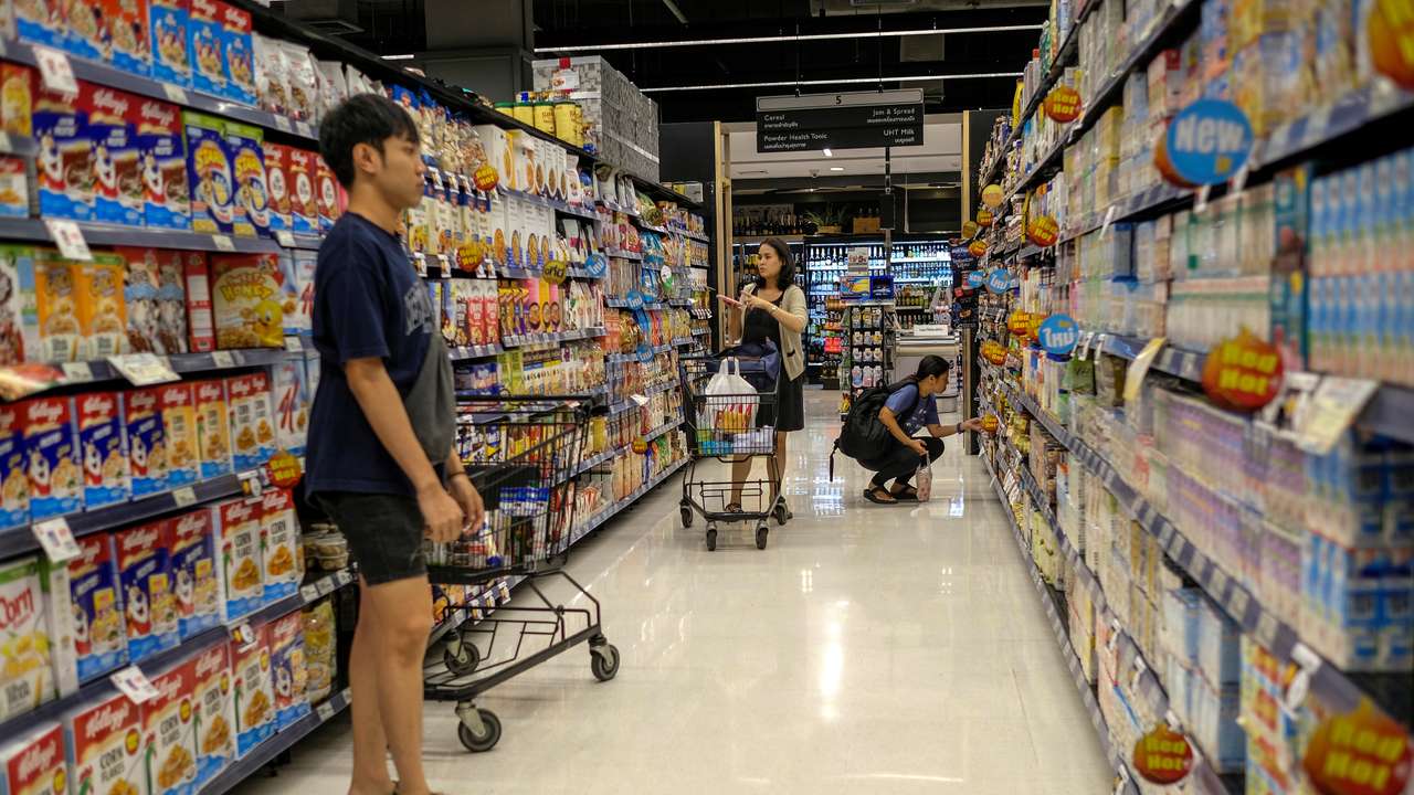 People shop at a supermarket inside a department store in central Bangkok