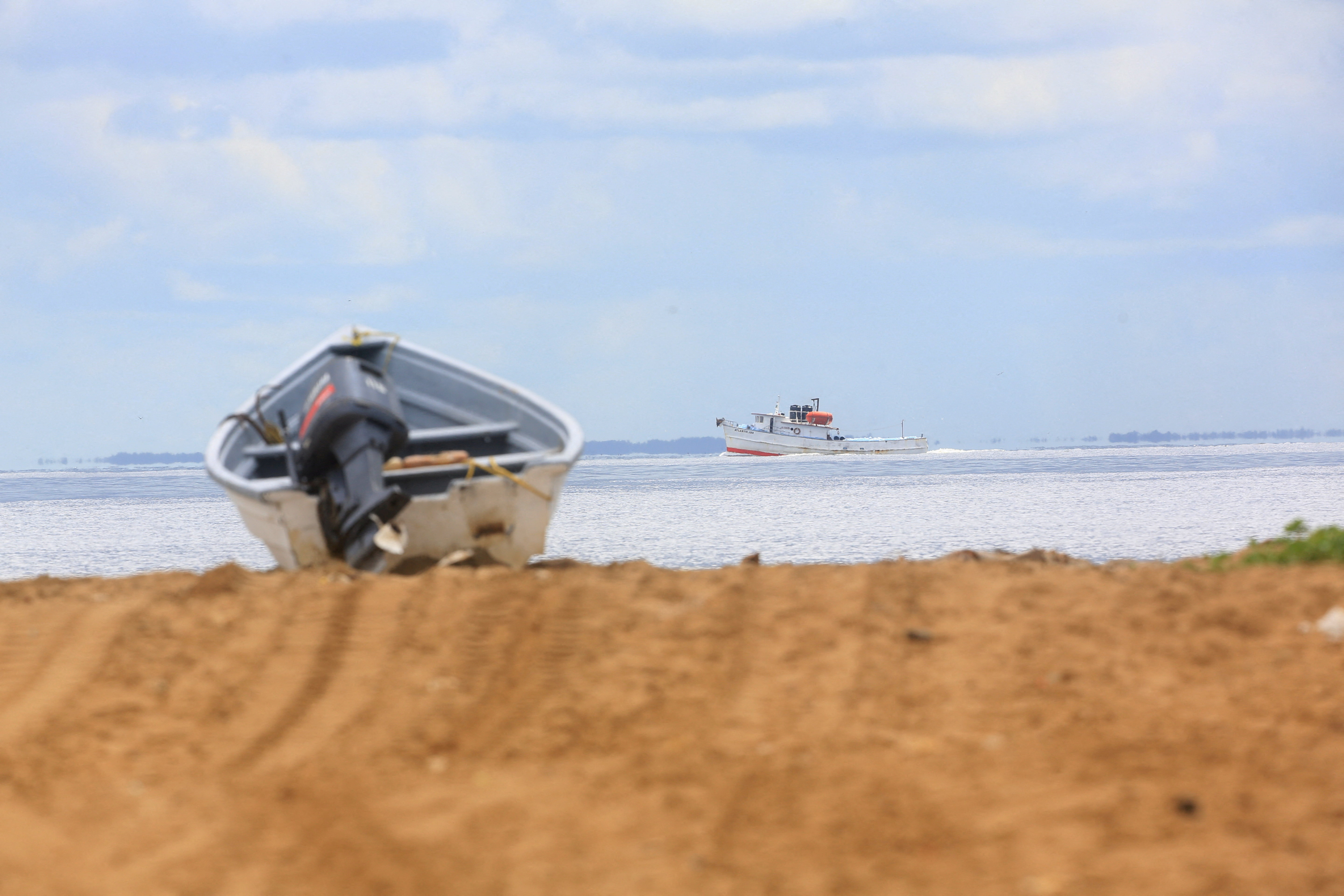 FILE PHOTO: A fishing trawler sails through the strait known as the Columbus Channel, at Icacos village