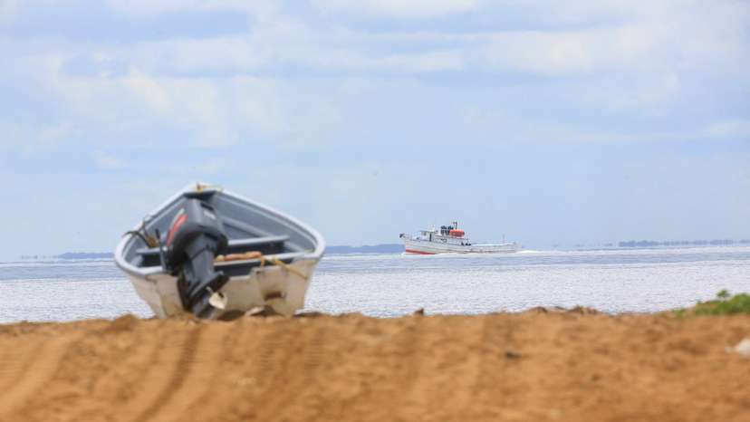 FILE PHOTO: A fishing trawler sails through the strait known as the Columbus Channel, at Icacos village