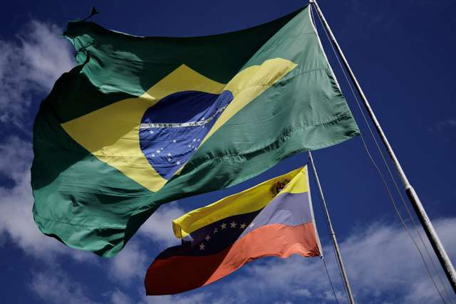 National flags of Brazil and Venezuela flutter at the Brazil-Venezuela border in the Brazilian city of Pacaraima