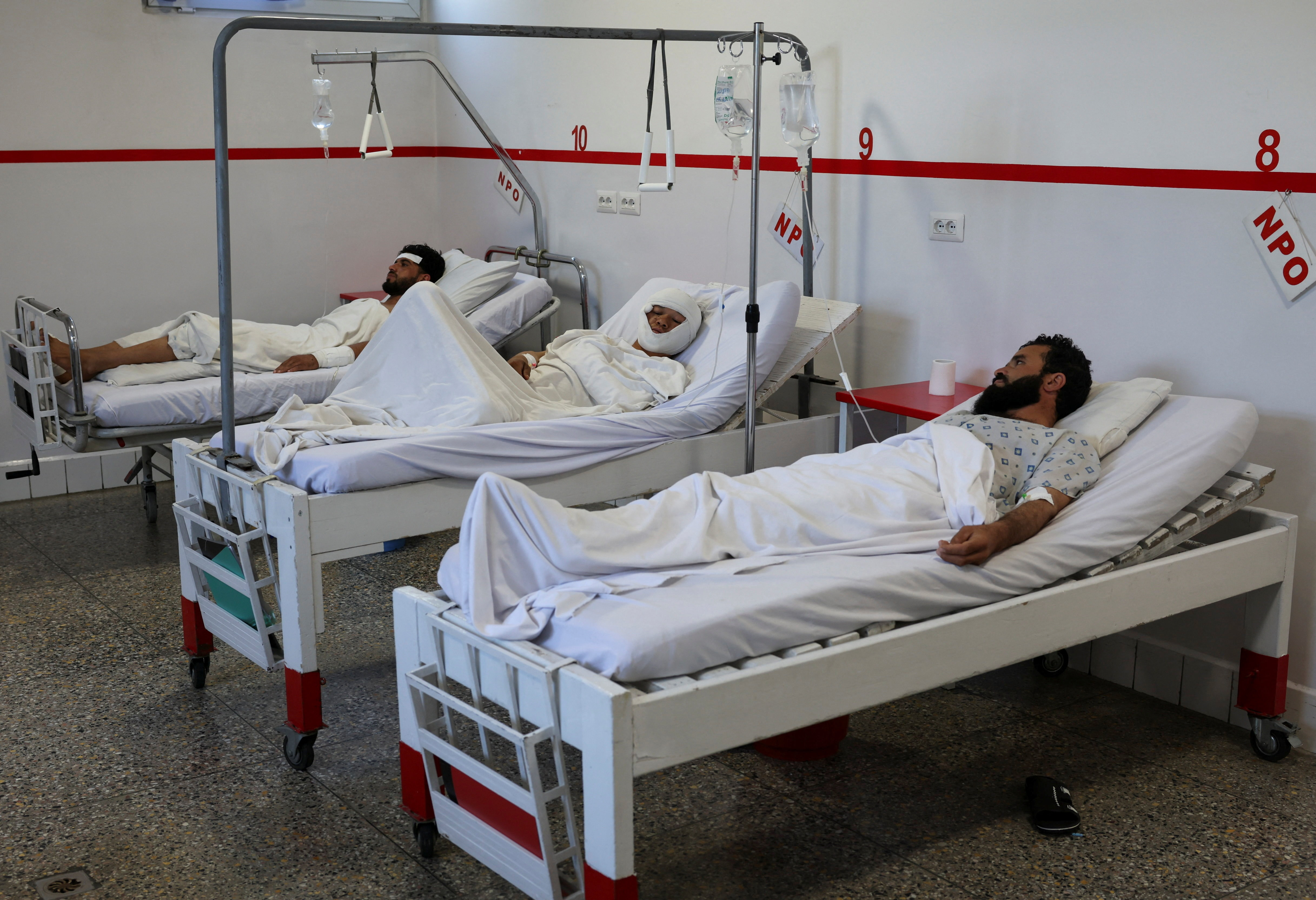 People injured during airstrikes amid the conflict between Afghanistan and Pakistan, lie on hospital beds following a temporary ceasefire, in Kabul
