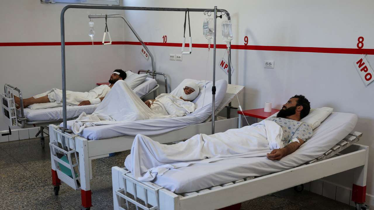 People injured during airstrikes amid the conflict between Afghanistan and Pakistan, lie on hospital beds following a temporary ceasefire, in Kabul