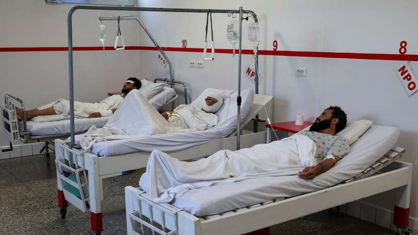 People injured during airstrikes amid the conflict between Afghanistan and Pakistan, lie on hospital beds following a temporary ceasefire, in Kabul