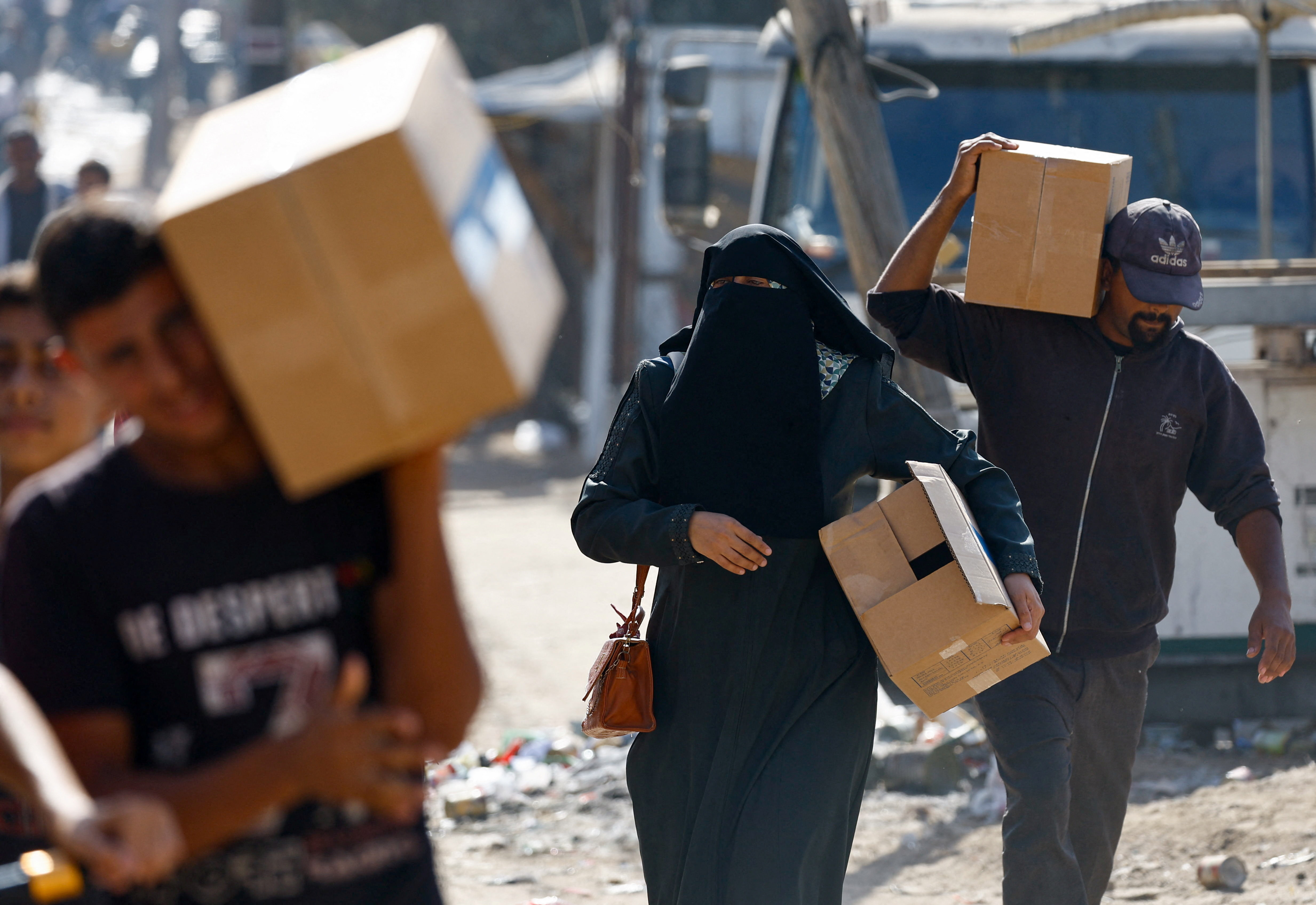 Palestinians carry aid that entered Gaza, in Zawaida