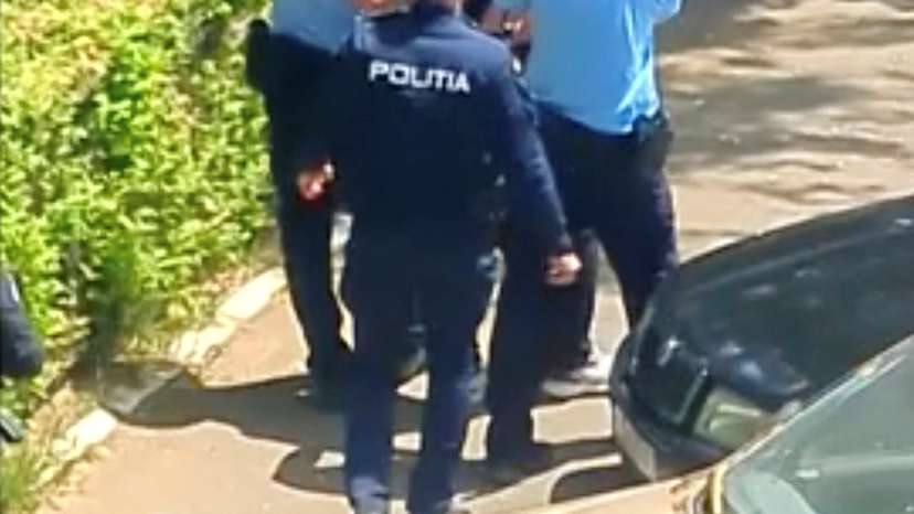 Romanian police escort suspect in Bucharest after Molotov cocktail was thrown at Israeli embassy