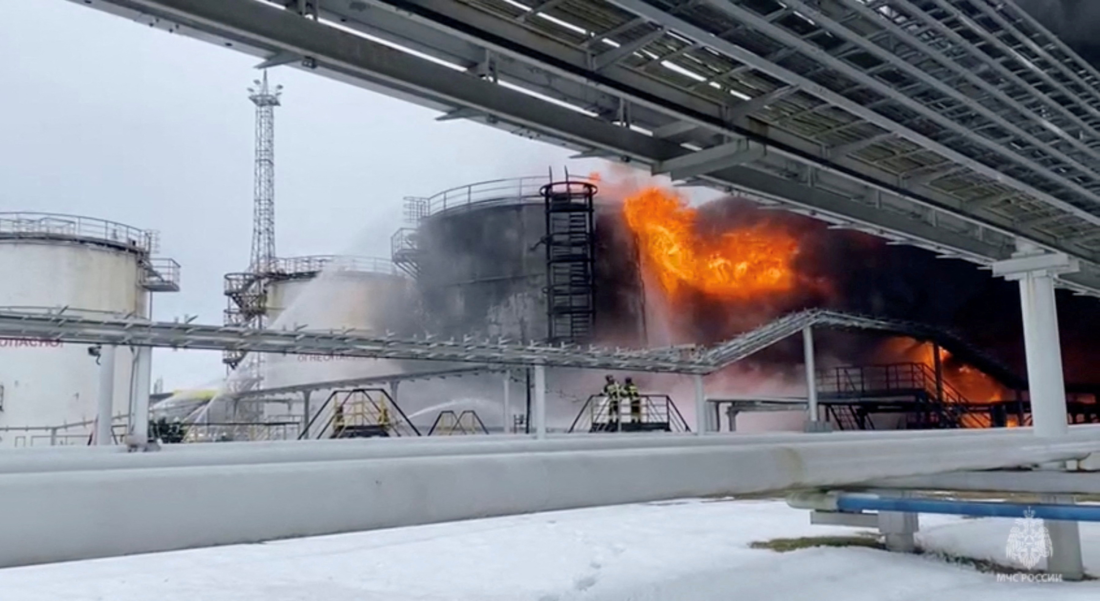 FILE PHOTO: Firefighters extinguish oil tanks at a storage facility in Klintsy