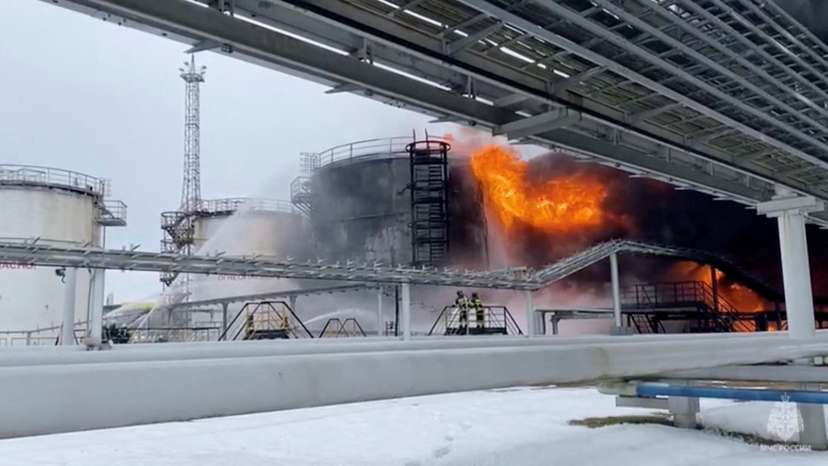 FILE PHOTO: Firefighters extinguish oil tanks at a storage facility in Klintsy