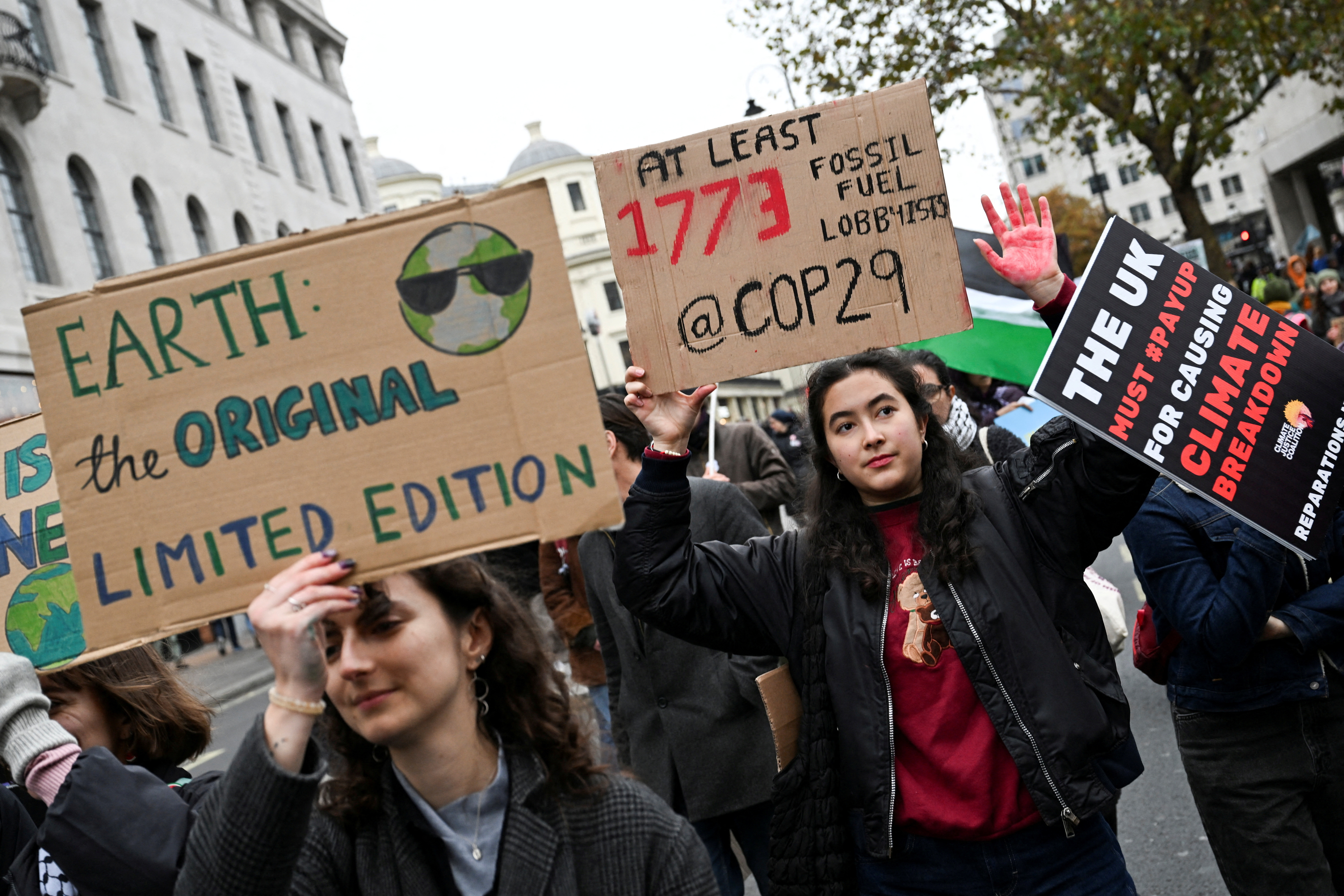 FILE PHOTO: People hold placards during a protest against the United Nations Climate Change Conference (COP29) in Baku, in London