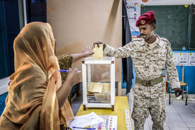 A member of the Djiboutian army casts his vote at a primary school serving as a polling station in Djibouti, on April 10, 2026, during the 2026 Djiboutian presidential elections. (Photo by Luis TATO / AFP)