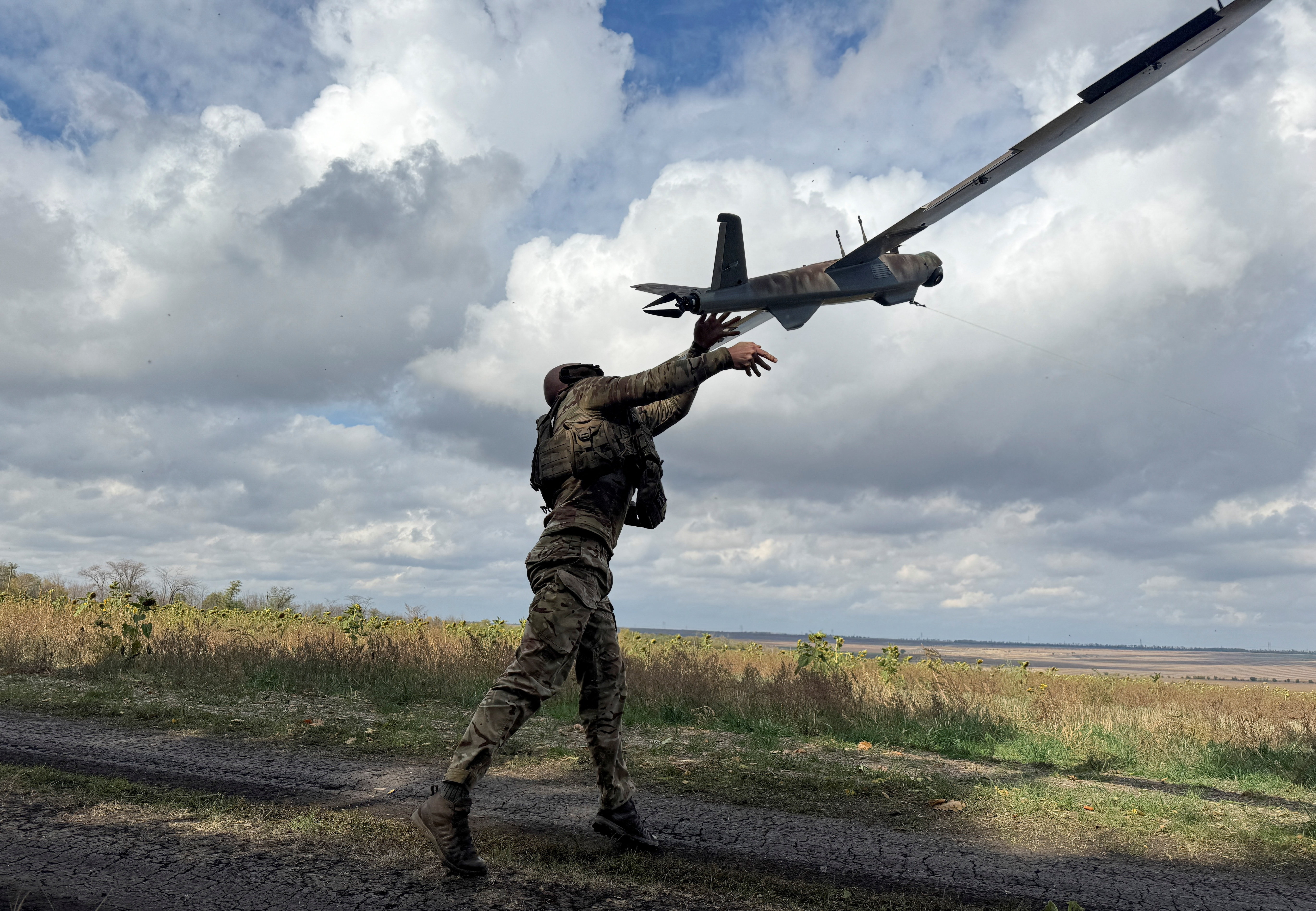 Ukrainian serviceman launches a reconnaissance drone near the frontline town of Pokrovsk