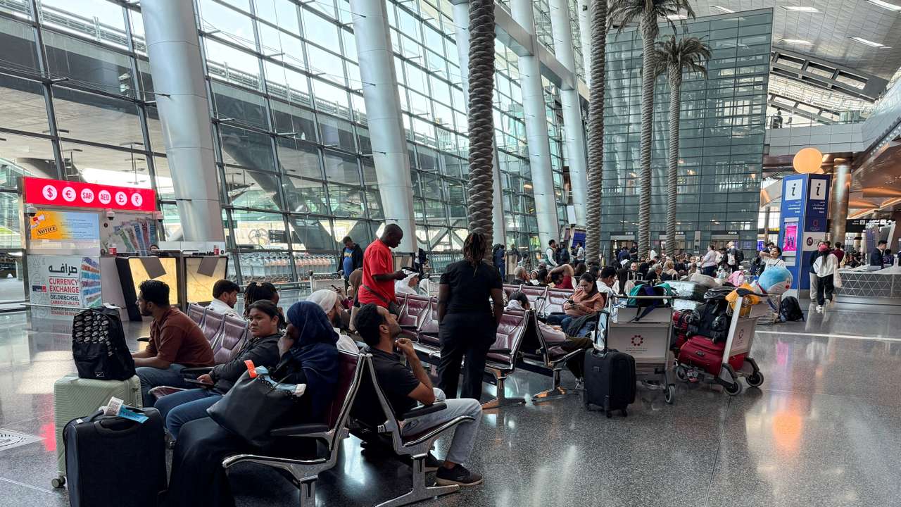 FILE PHOTO: People sit at Hamad International Airport, in Doha