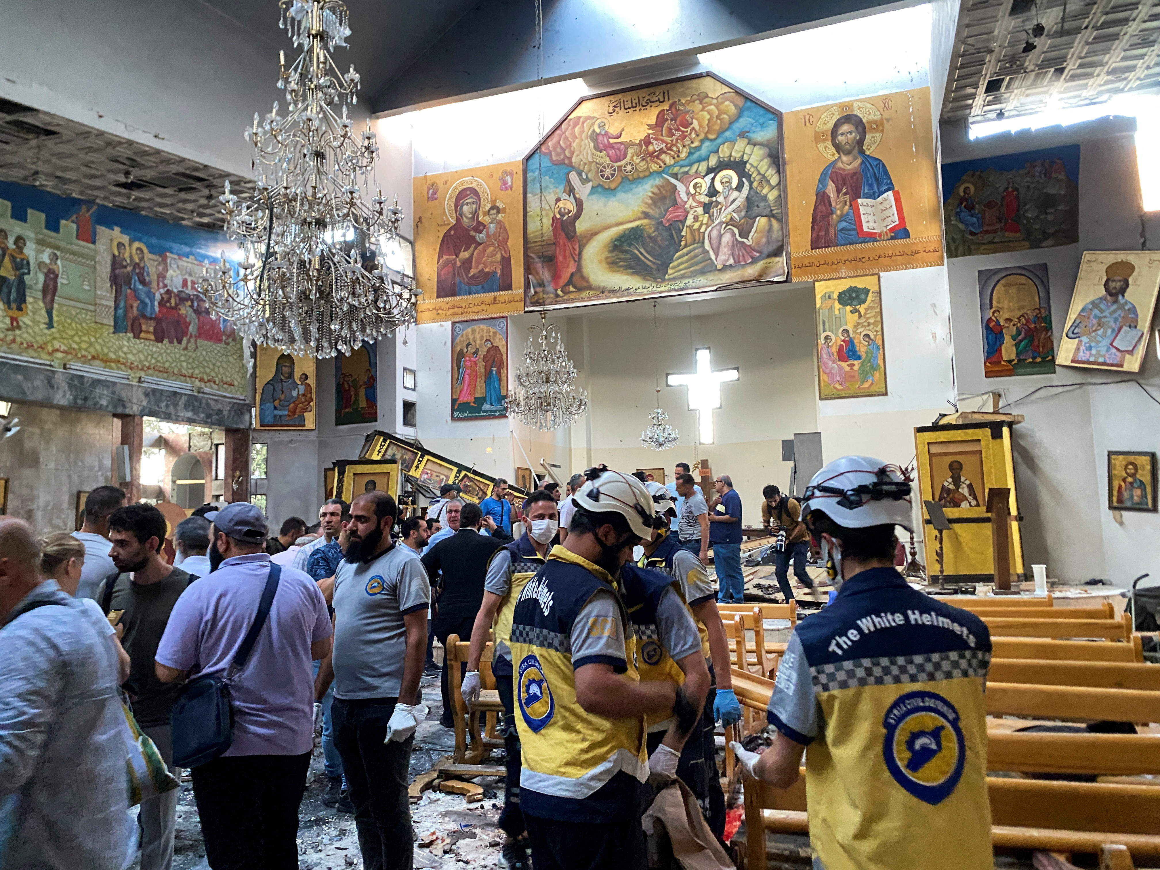 People and civil defence members inspect the damage after a blast rocked the Mar Elias Church in the Dweila neighbourhood of Damascus