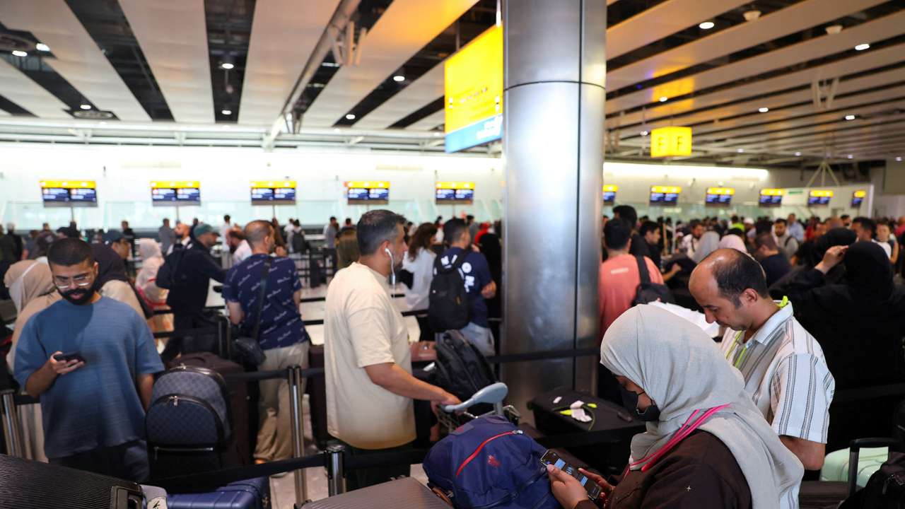 FILE PHOTO: Travellers at Heathrow Airport amid cyberattack disruptions, in Greater London