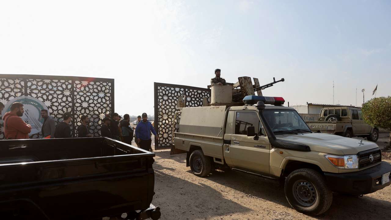 FILE PHOTO: Members of an Iraqi Shi'ite armed group sit in a vehicle after an attack by a drone strike on an Iran-backed militia headquarters in Baghdad