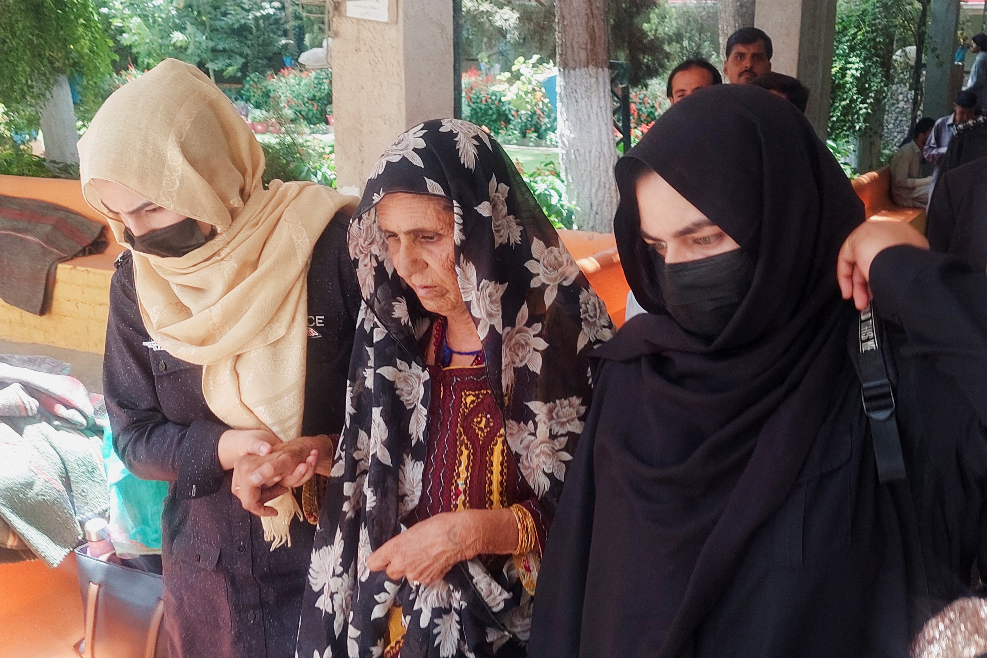 Policewomen escort Gul Jan Bibi, at a local court in Quetta